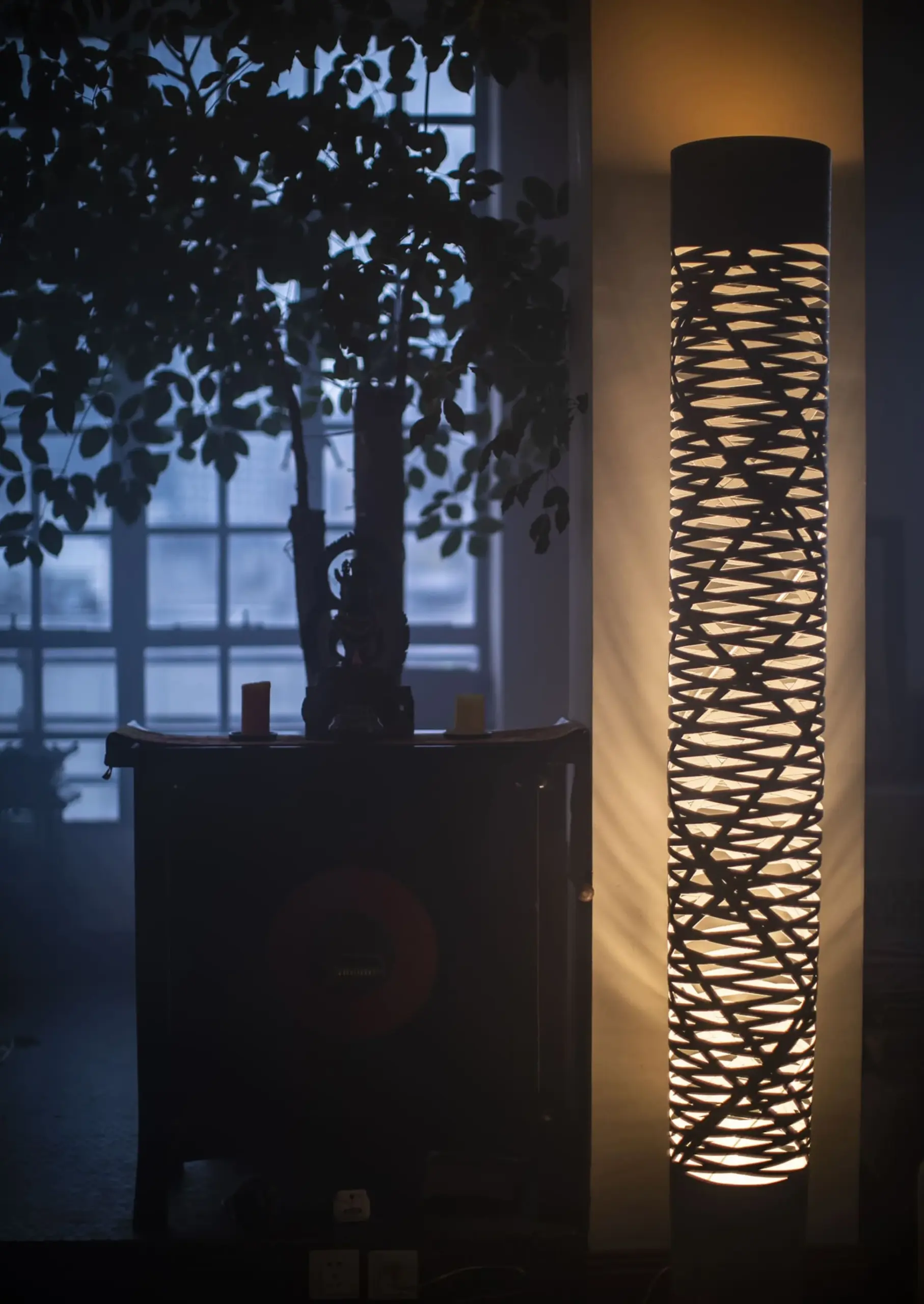 Foscarini Stehlampe Tress mit geflochtenem Schirm im abendlichen Wohnzimmer