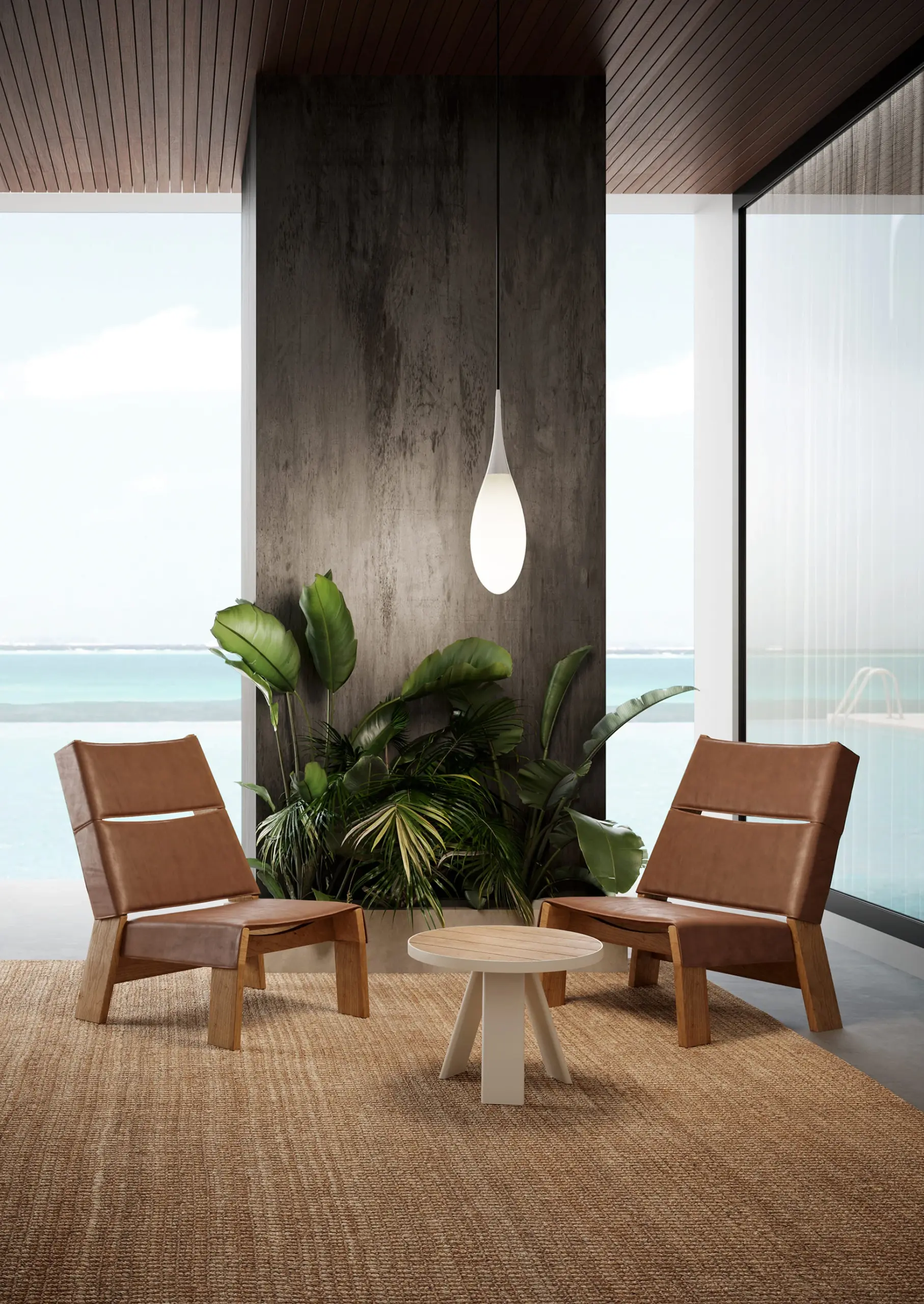 Weiße KDLN Outdoor-Pendelleuchte Spillo in Tropfenform auf einer Terrasse am Meer